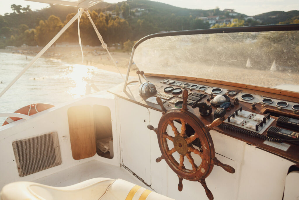 sun shines over wooden boat in the sea