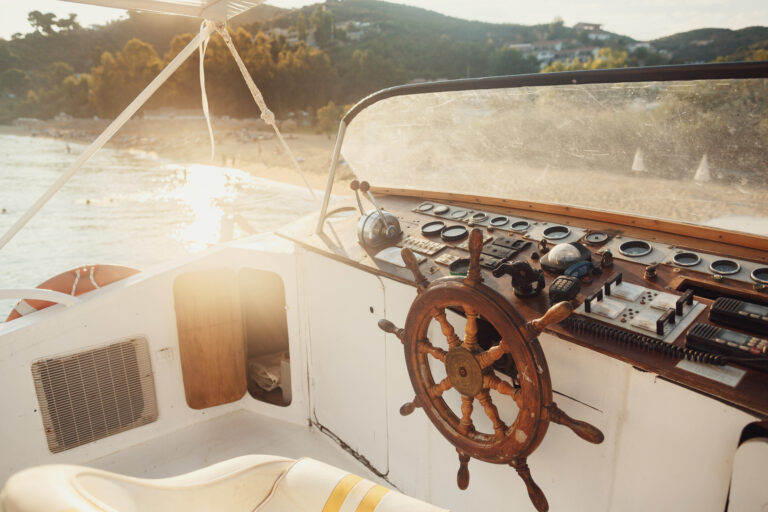 sun shines over wooden boat in the sea